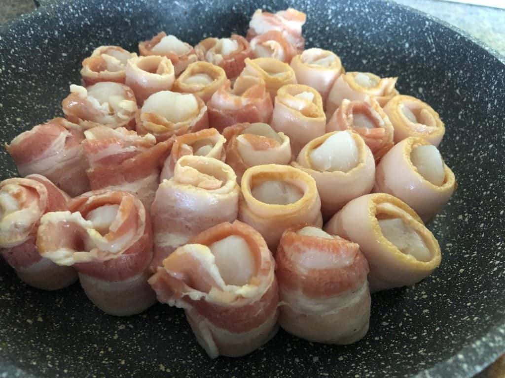 Bacon Wrapped scallops-bunch of rolled raw scallops in bacon